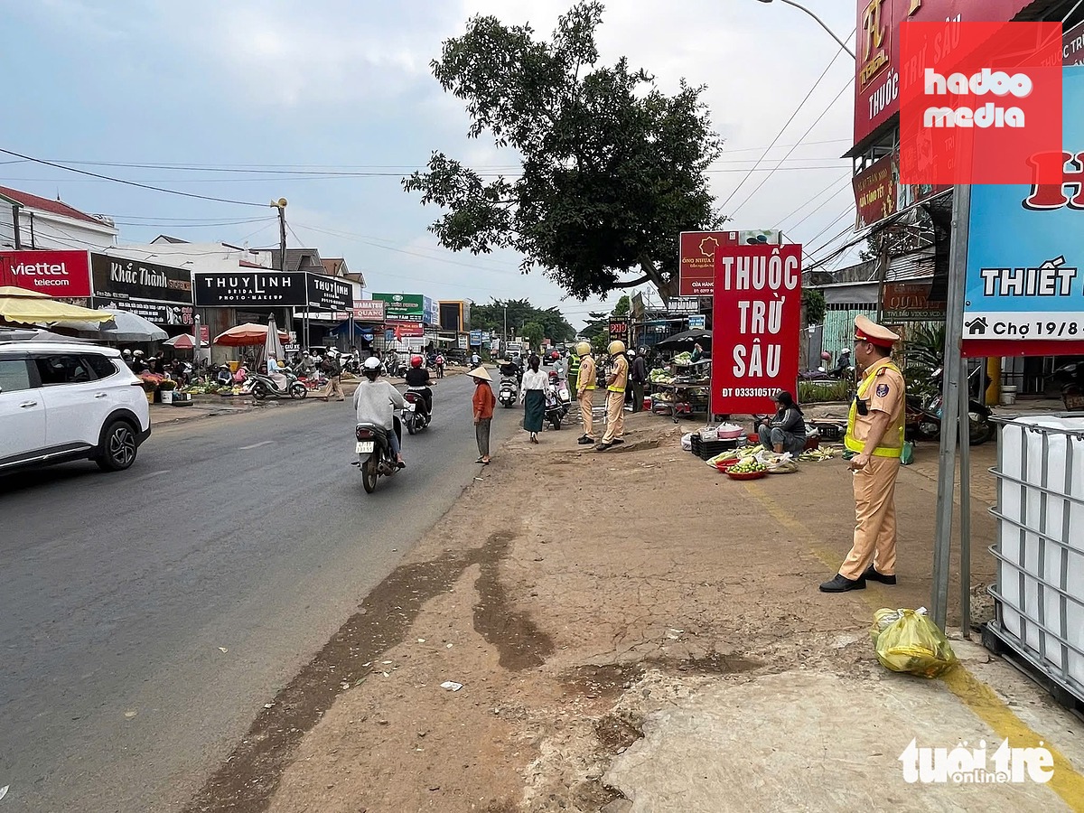 Lực lượng cảnh sát giao thông Công an tỉnh Đắk Lắk cùng công an địa phương ra quân ngăn tiểu thương lấn lòng lề đường - Ảnh: MINH PHƯƠNG