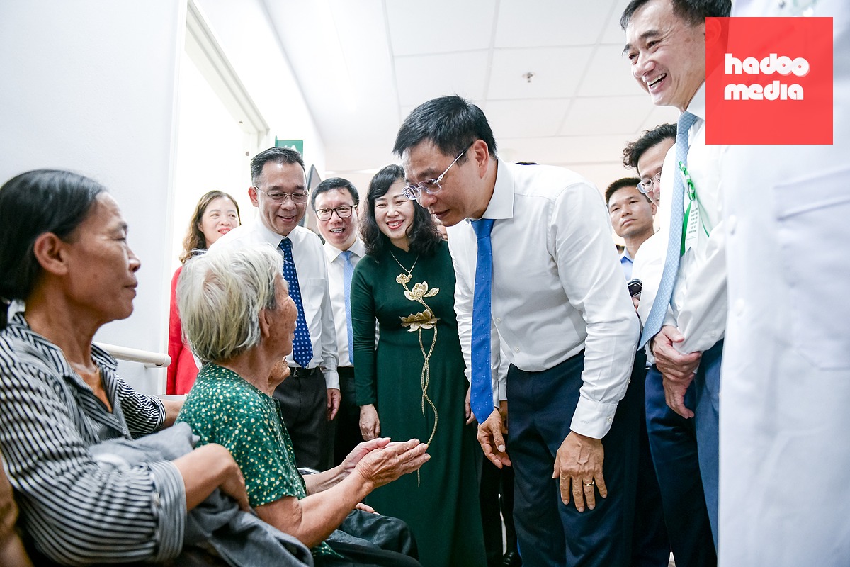 Các đại biểu thăm hỏi người bệnh đến thăm khám - Ảnh: NAM TRẦN