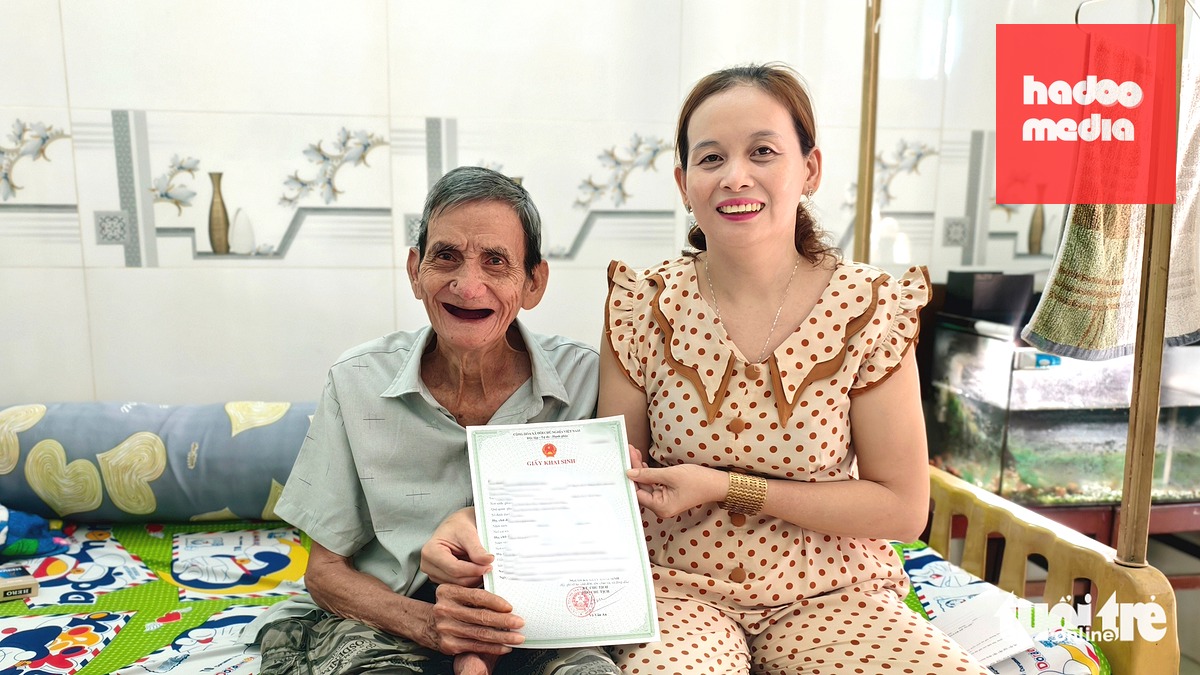 Ông Hoàng Huynh cùng con gái bên giấy khai sinh do UBND phường Tân Tạo cấp - Ảnh: NGỌC KHẢI