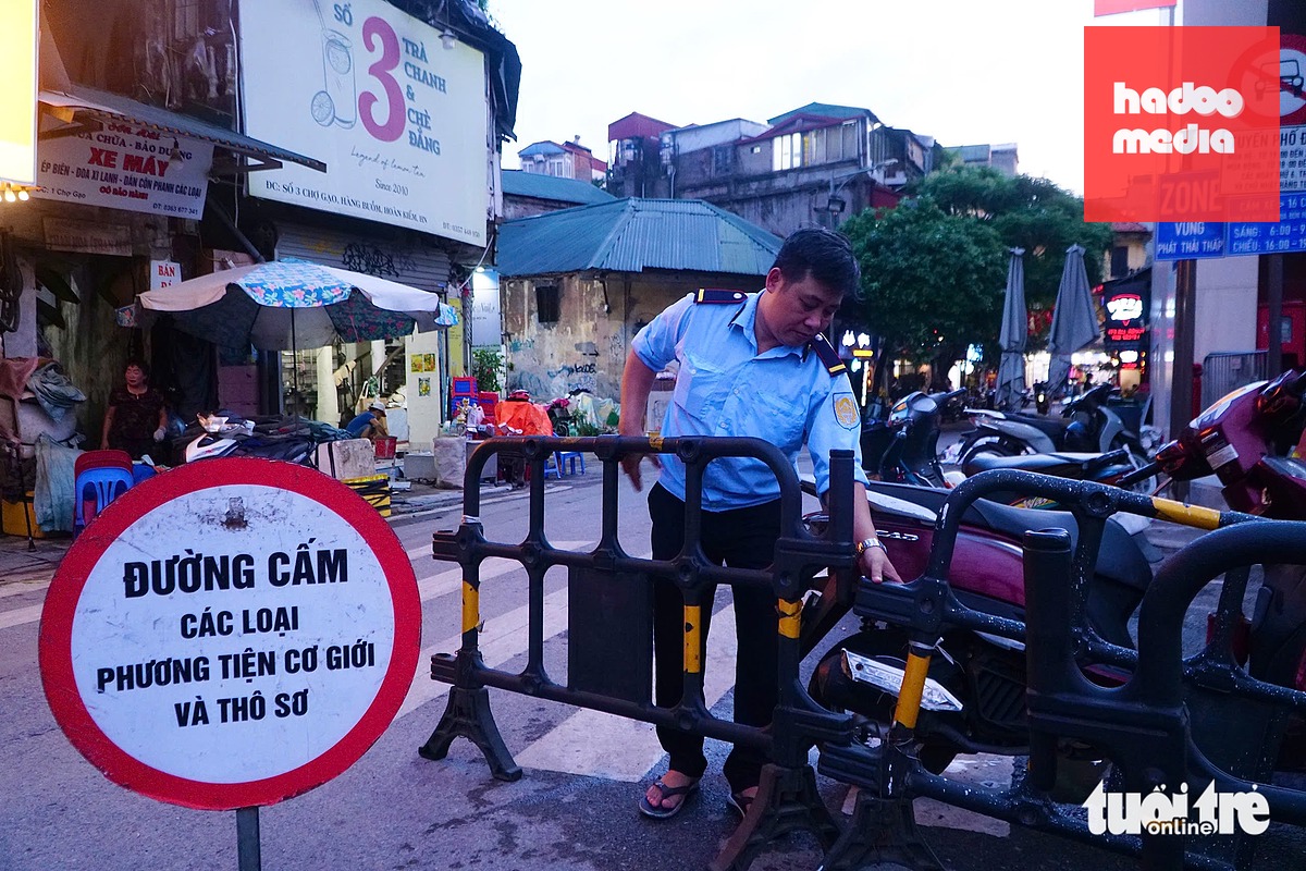 Thời điểm trước 19h ngày 4-7, lực lượng chức năng chuẩn bị để thiết lập rào chắn cho vùng phát thải thấp - Ảnh: PHẠM TUẤN