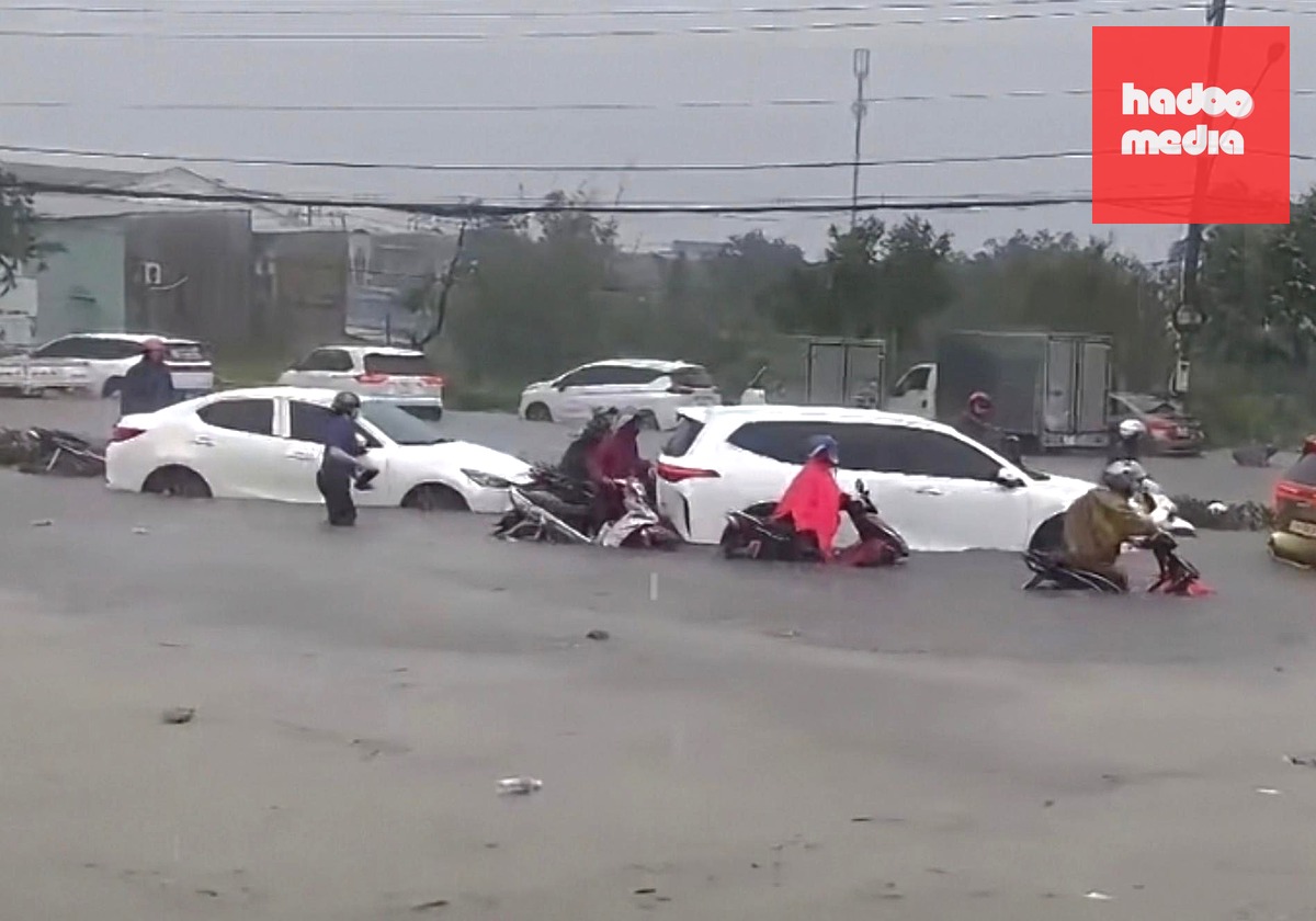 Trước đó, mưa lớn kéo dài từ chiều 25-9 khiến nhiều tuyến đường bị ngập. Trong ảnh: người dân lưu thông qua đường ĐT 746, phường Tân Hiệp, TP.HCM phải dắt bộ do có vị trí nước ngập hết bánh xe - Ảnh: C.T.V.
