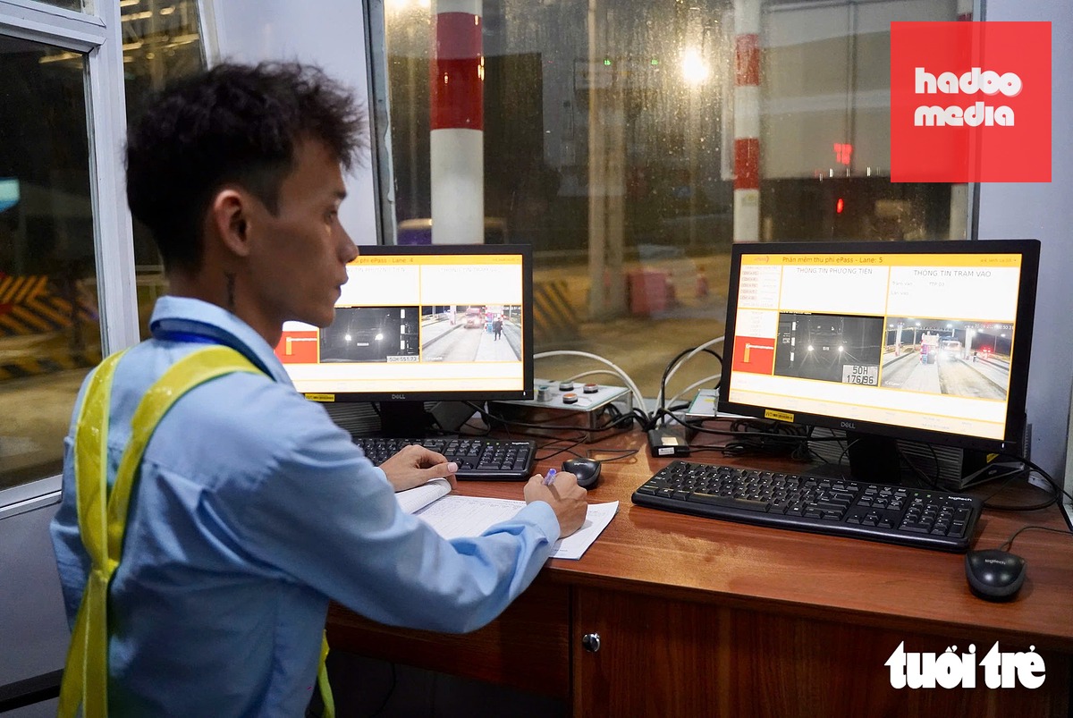 Nhân viên giám sát các phương tiện ra vào trạm thu phí số 4 - Ảnh: THUẬN VĂN