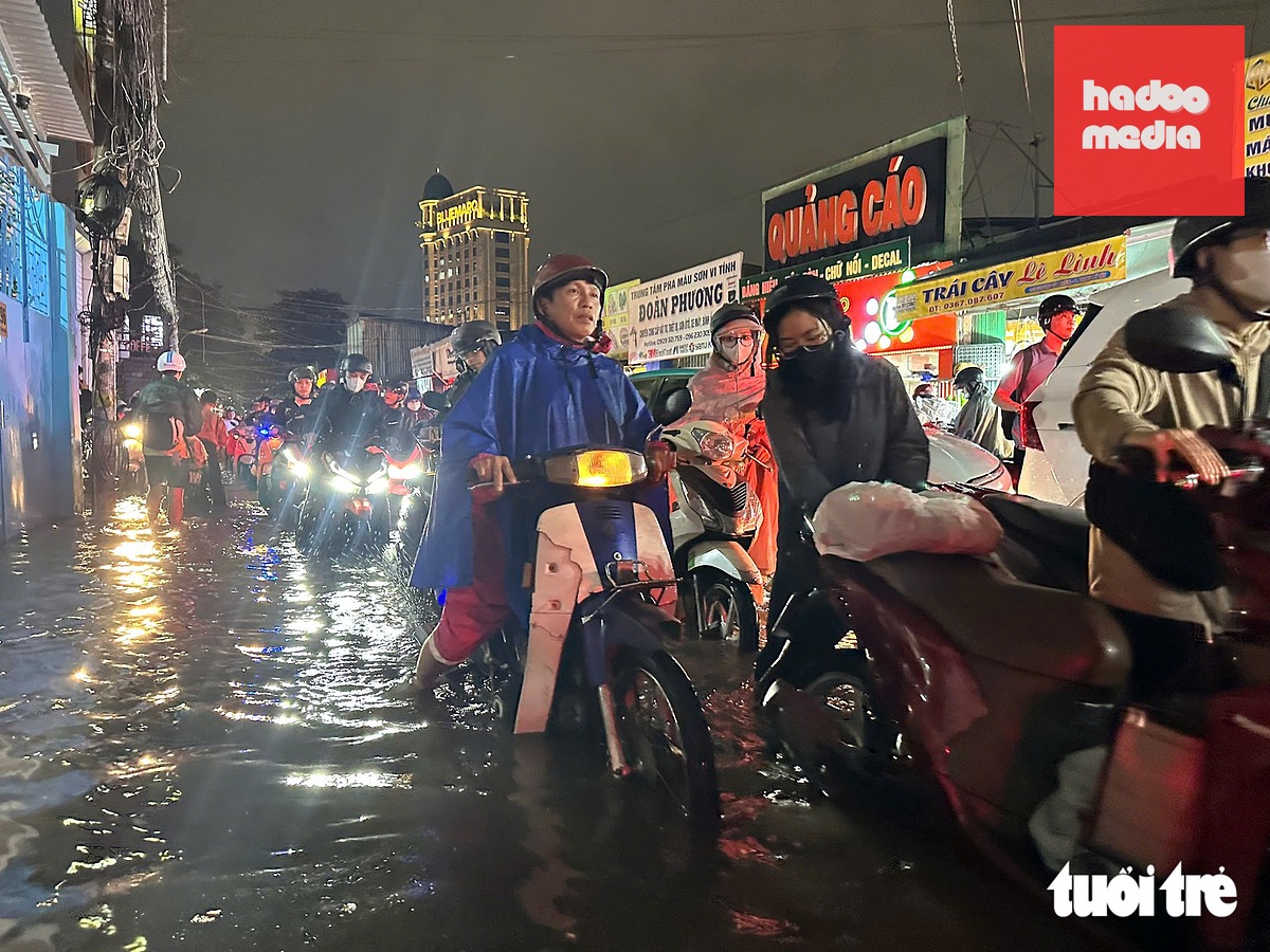 Người dân chật vật trong cơn mưa ngập và kẹt xe tối 1-10 - Ảnh: CAM LY